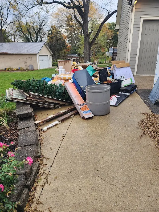 Dumpster being loaded with debris for Roofing Dumpster Rental in Palestine